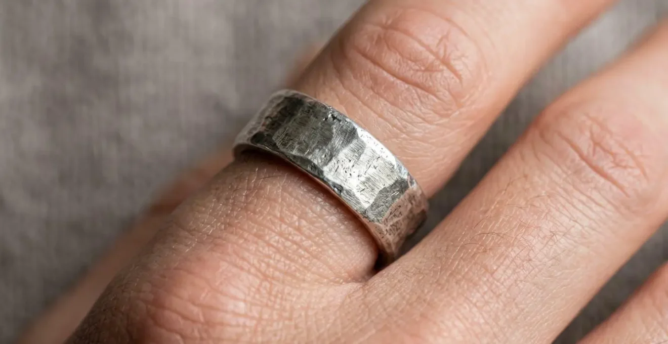 Gros plan détaillé d'une bague large sur un doigt montrant l'ajustement optimal